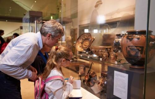 Teacher And Pupils Looking At Artifacts On Display In Museum GETTY.jpg